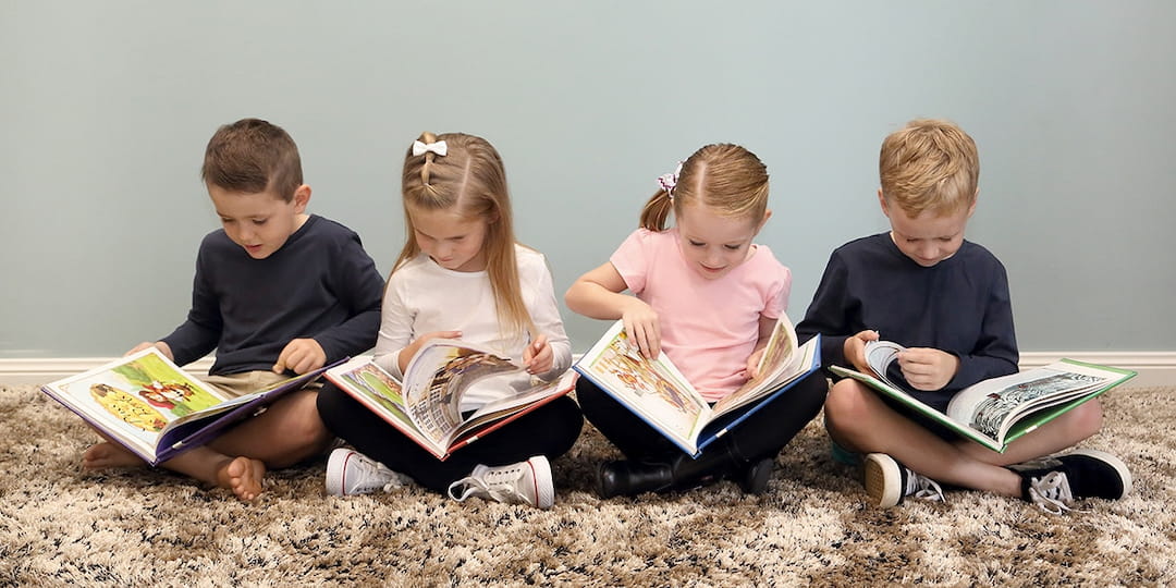 a group of children reading books