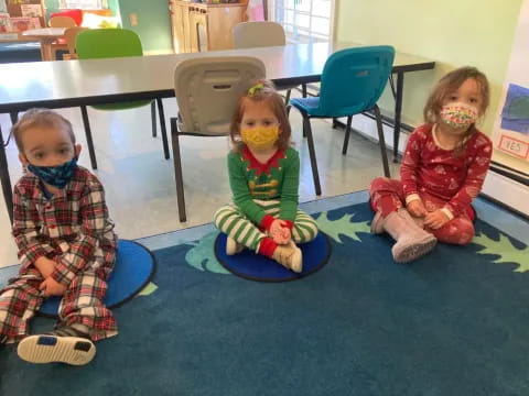 a couple of children sitting on the floor