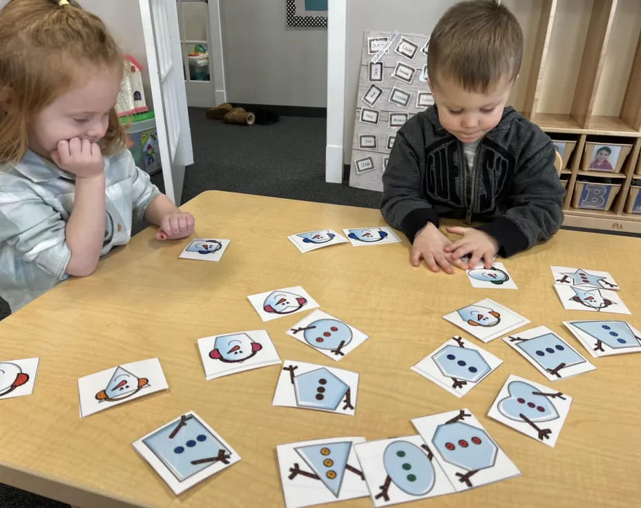 a couple of kids playing cards