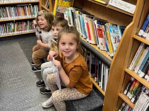 a group of children sitting in a library