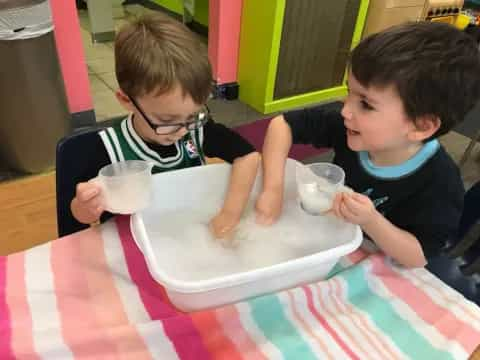 two boys playing with cups