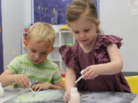 a couple of children painting