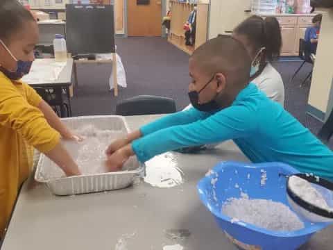 a group of children making a cake