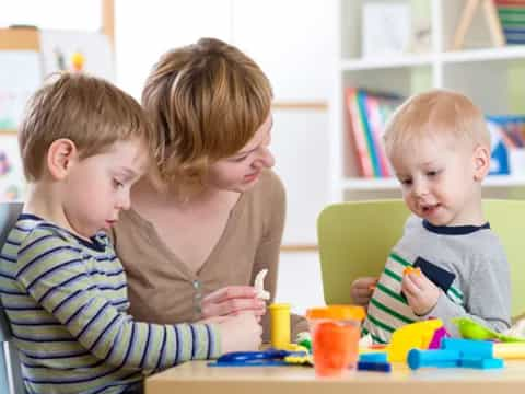 a group of children sitting at a table