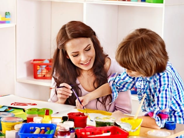 a woman and a child painting