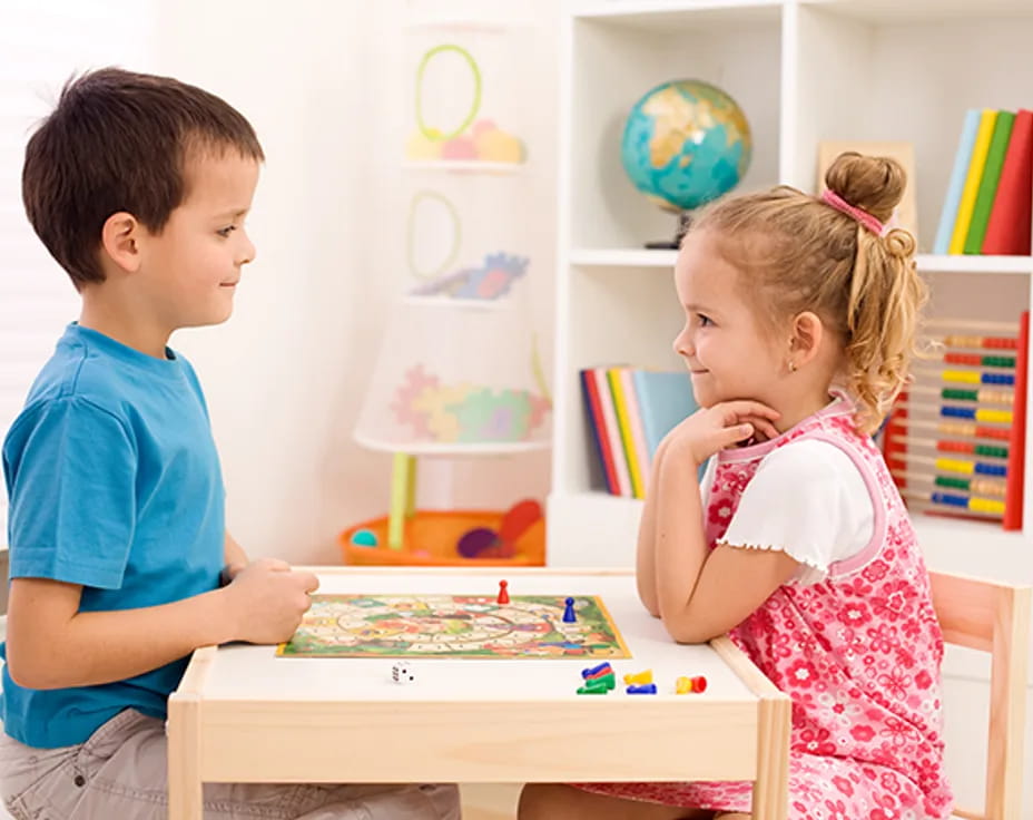 a boy and girl playing a board game