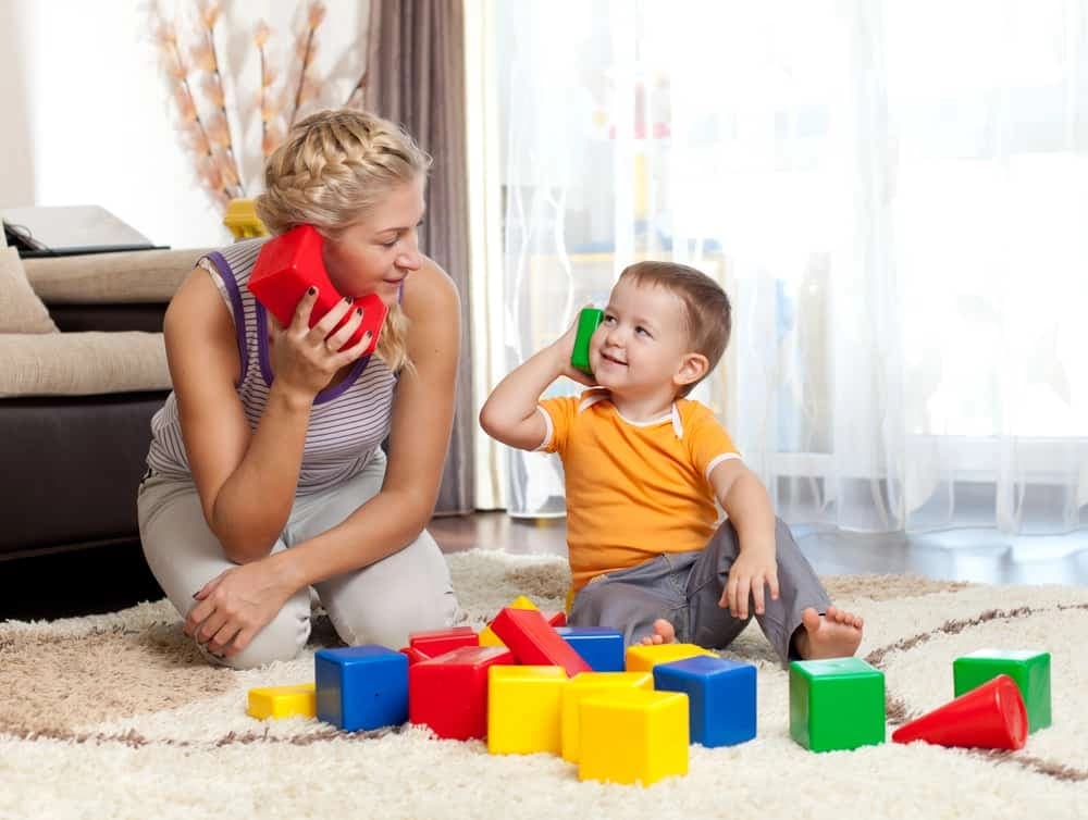 a person and a child playing with toys