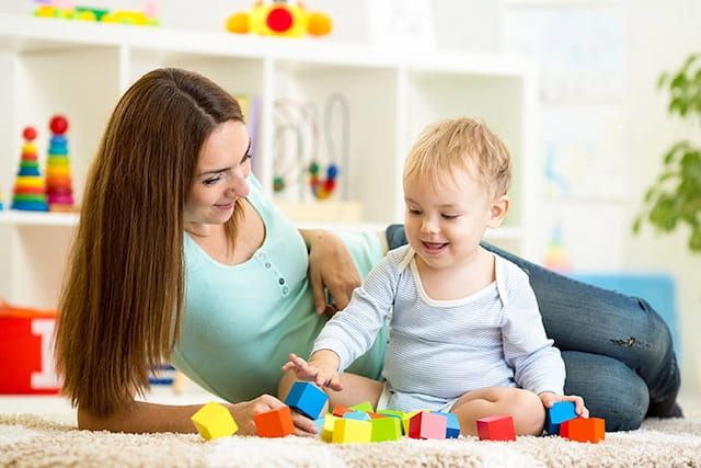 a person and a child playing with toys