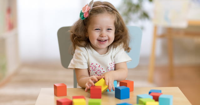 a girl playing with blocks