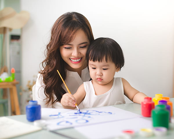 a person and a child painting