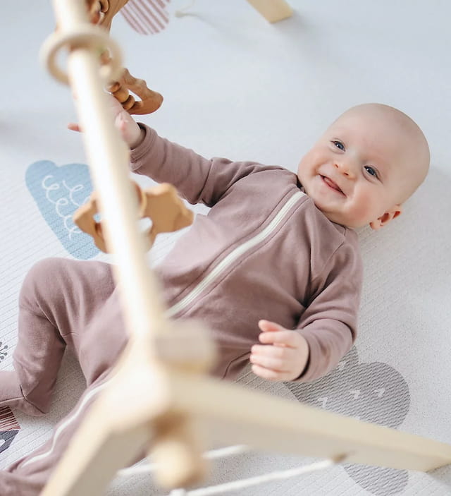 a baby lying on a white surface