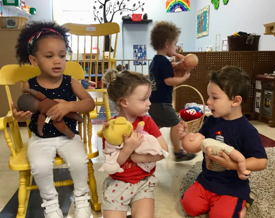 a group of children sitting in chairs