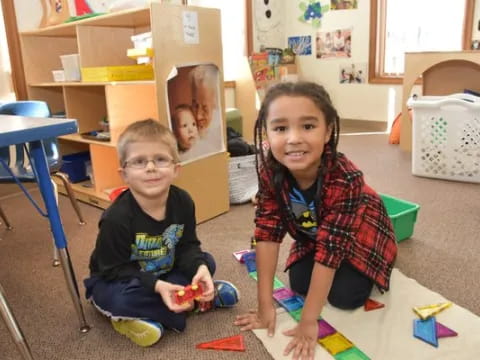 a couple of children sitting on the floor