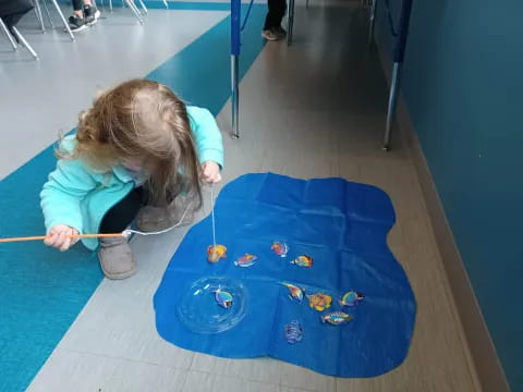 a girl painting on a blue table