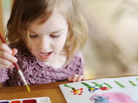 a girl coloring on a book