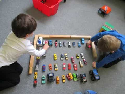 a couple of people playing with toys