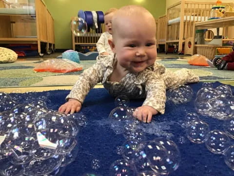 a baby crawling on a blue surface