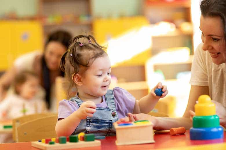 a young girl playing with a toy