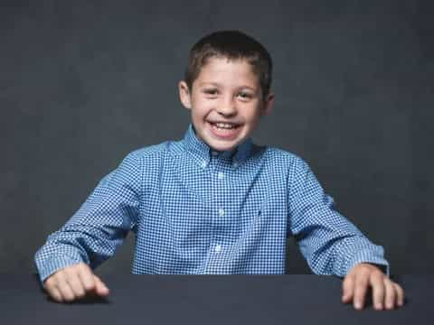 a boy smiling at the camera