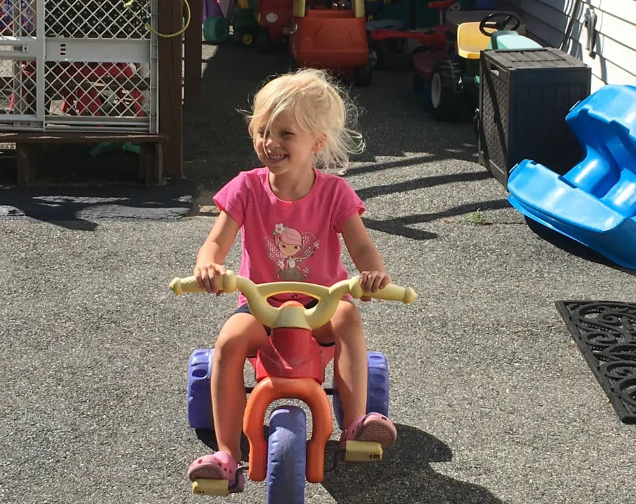 a girl riding a toy bike