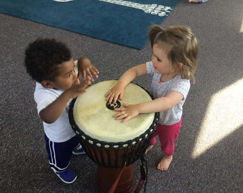 a couple of children playing with a toy