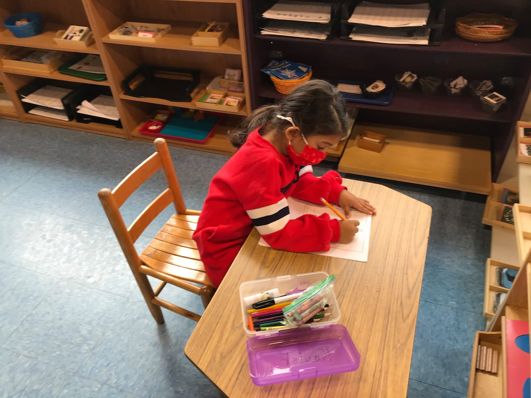 a girl sitting at a table