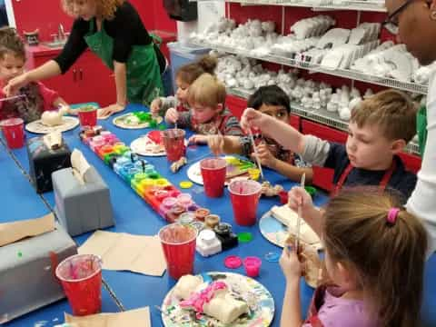 a group of children eating at a table