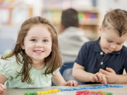 a boy and girl sitting at a table