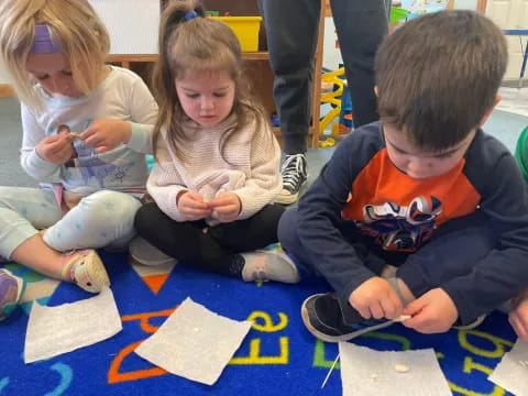 a group of children sitting on the floor