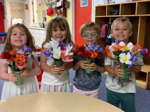 a group of children holding flowers