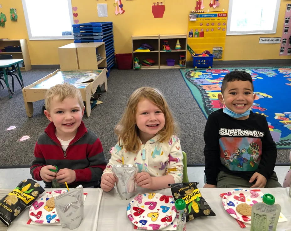 a group of children sitting on the floor with toys