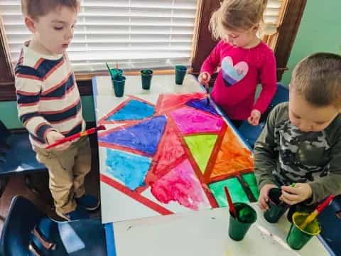 children painting on a table