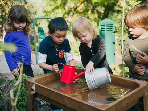 a group of children working in a garden