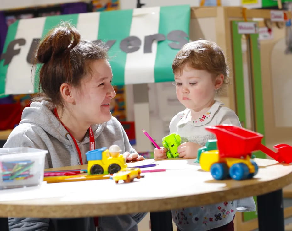 a person and a child playing with toys