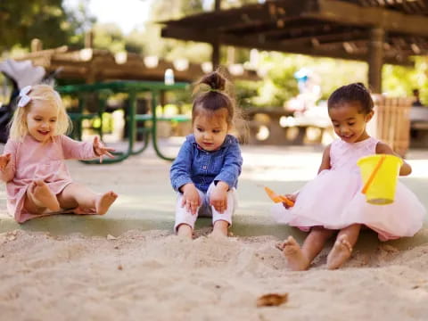 a group of children playing in sand