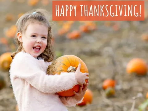 a girl holding a pumpkin