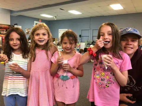 a group of people holding toothbrushes