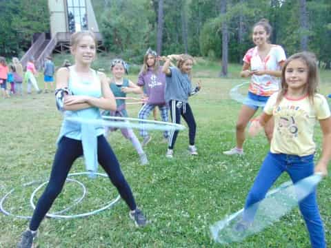 a group of girls playing with bows and arrows