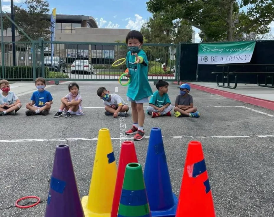 a girl standing between several cones