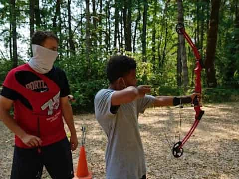 a man shooting a bow and arrow