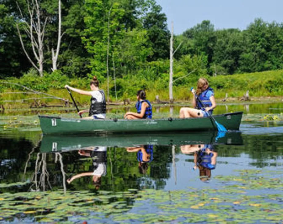 a group of people in a canoe on a lake