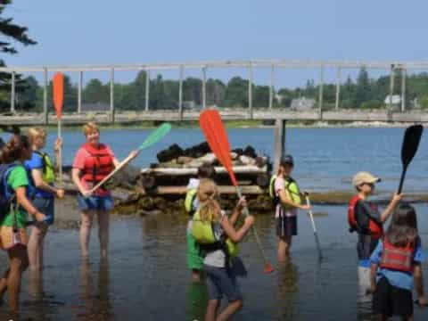 a group of people holding paddles