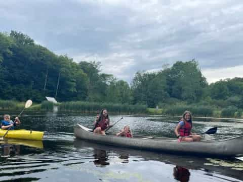 a group of people in canoes on a lake