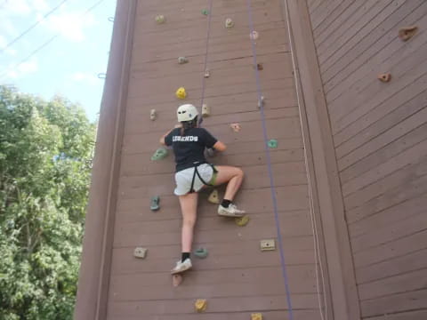 a person climbing a wooden wall