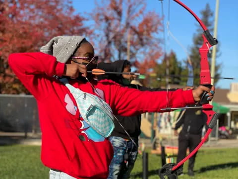 a person shooting a bow and arrow