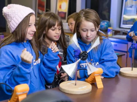 a group of girls in blue shirts