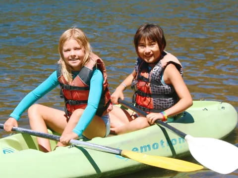 a couple of girls in a canoe