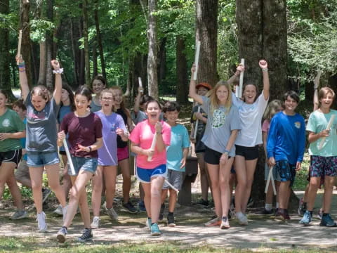 a group of people posing for a photo in the woods