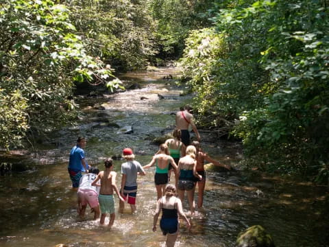 a group of people standing in a river