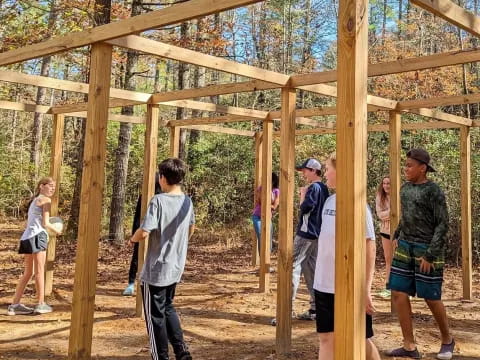 a group of people standing in a wooden structure